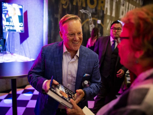 Sean Spicer signing a copy of his new book at an earlier event in Washington DC