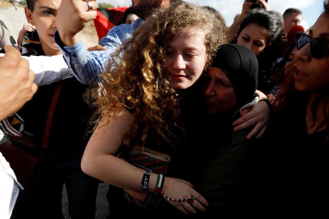 Palestinian teenager Ahed Tamimi is welcomed by relatives and supporters after she was released from an Israeli prison