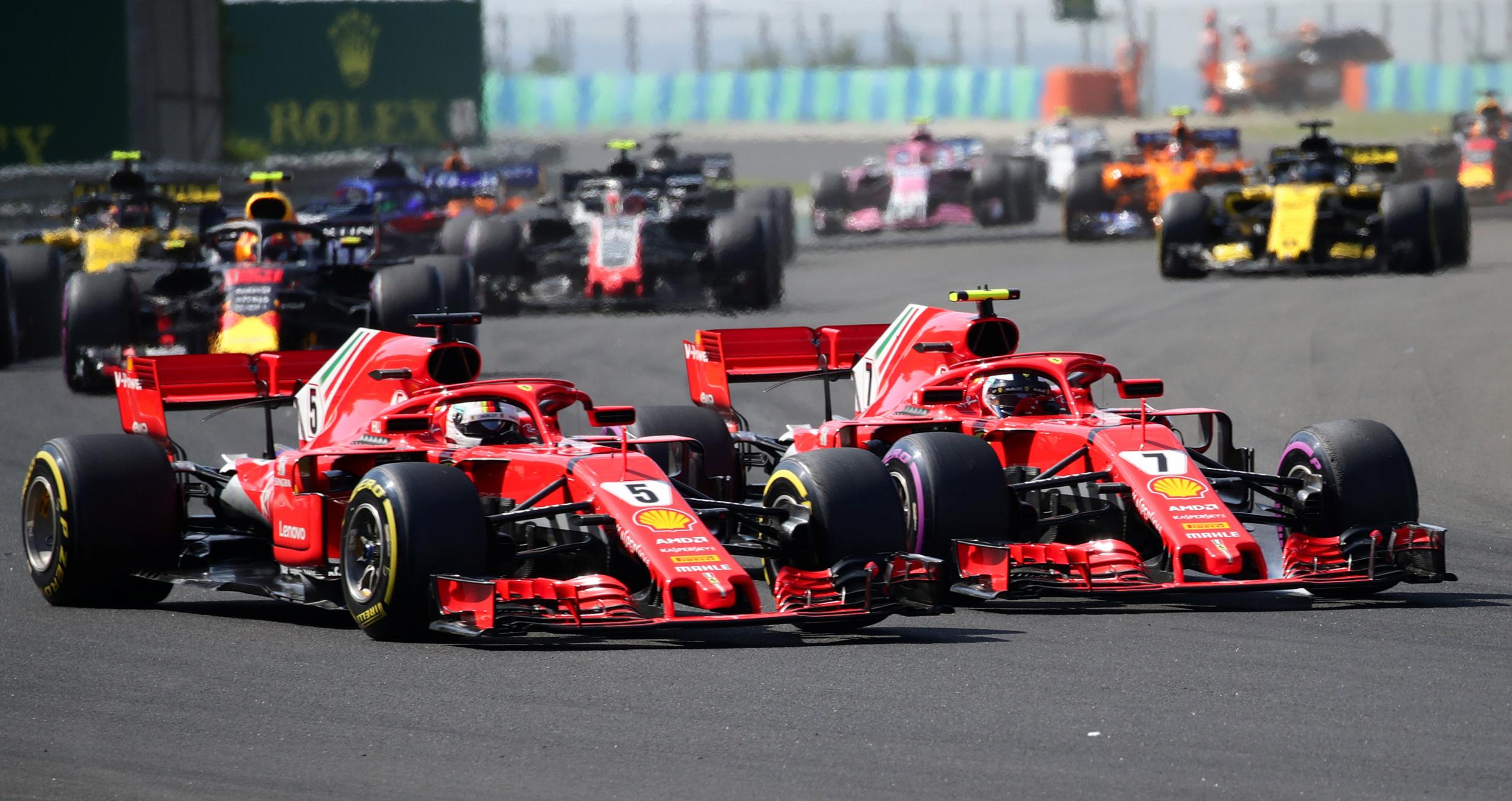 Sebastian Vettel passes Kimi Raikkonen on the outside of turn two