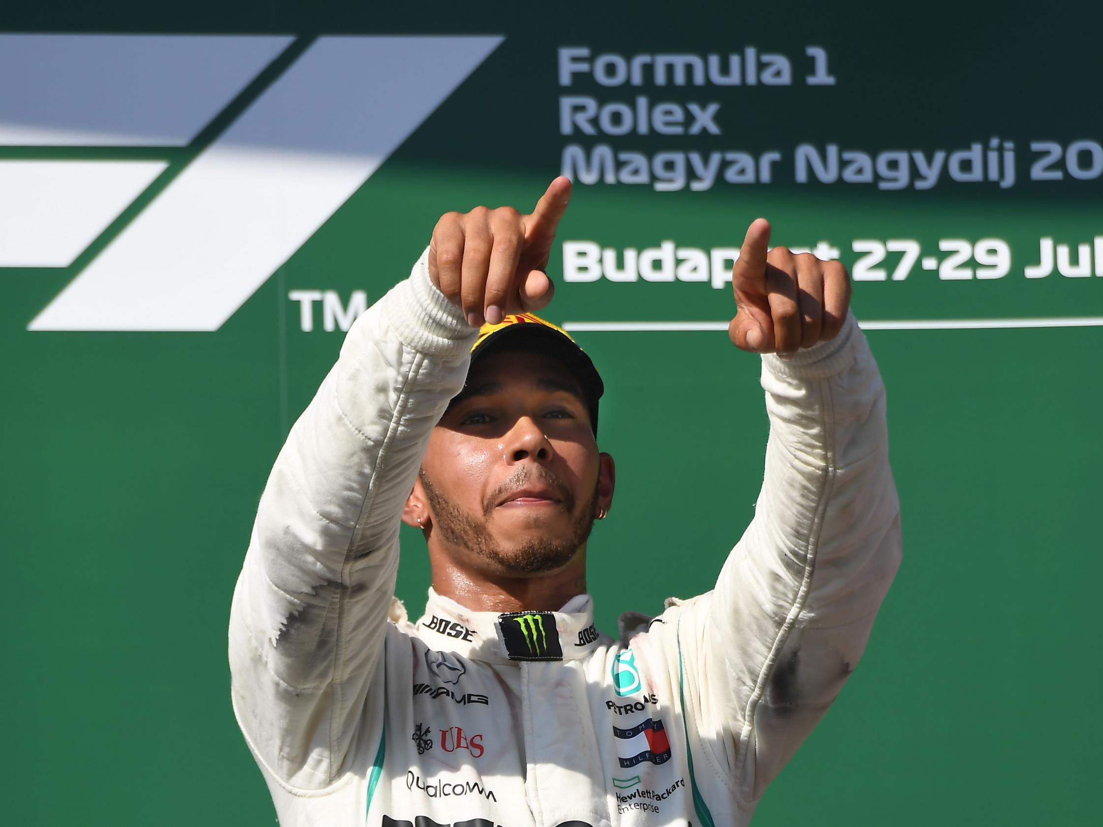 Hamilton celebrates his victory up on the podium