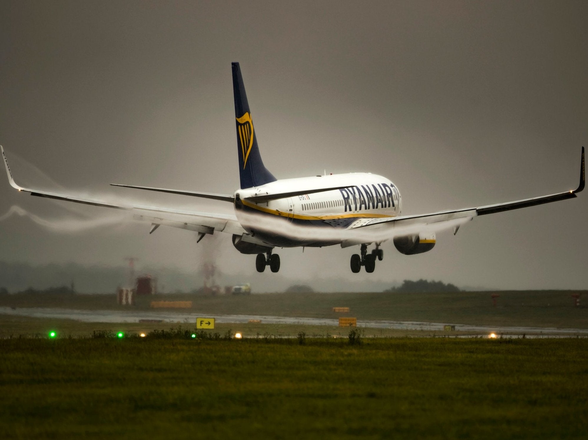 A Ryanair plane comes in to land in rainy conditions at Leeds Bradford Airport