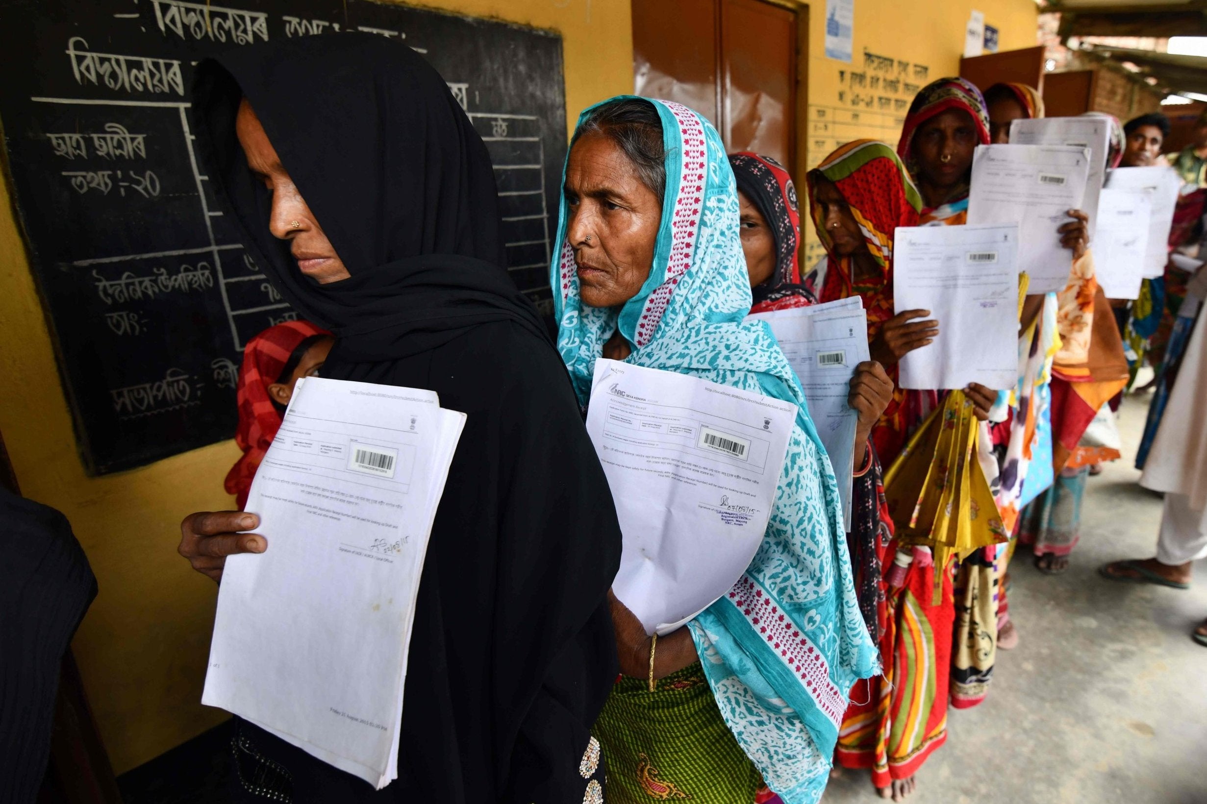 Residents queue to check their names on the final list of the National Register of Citizens