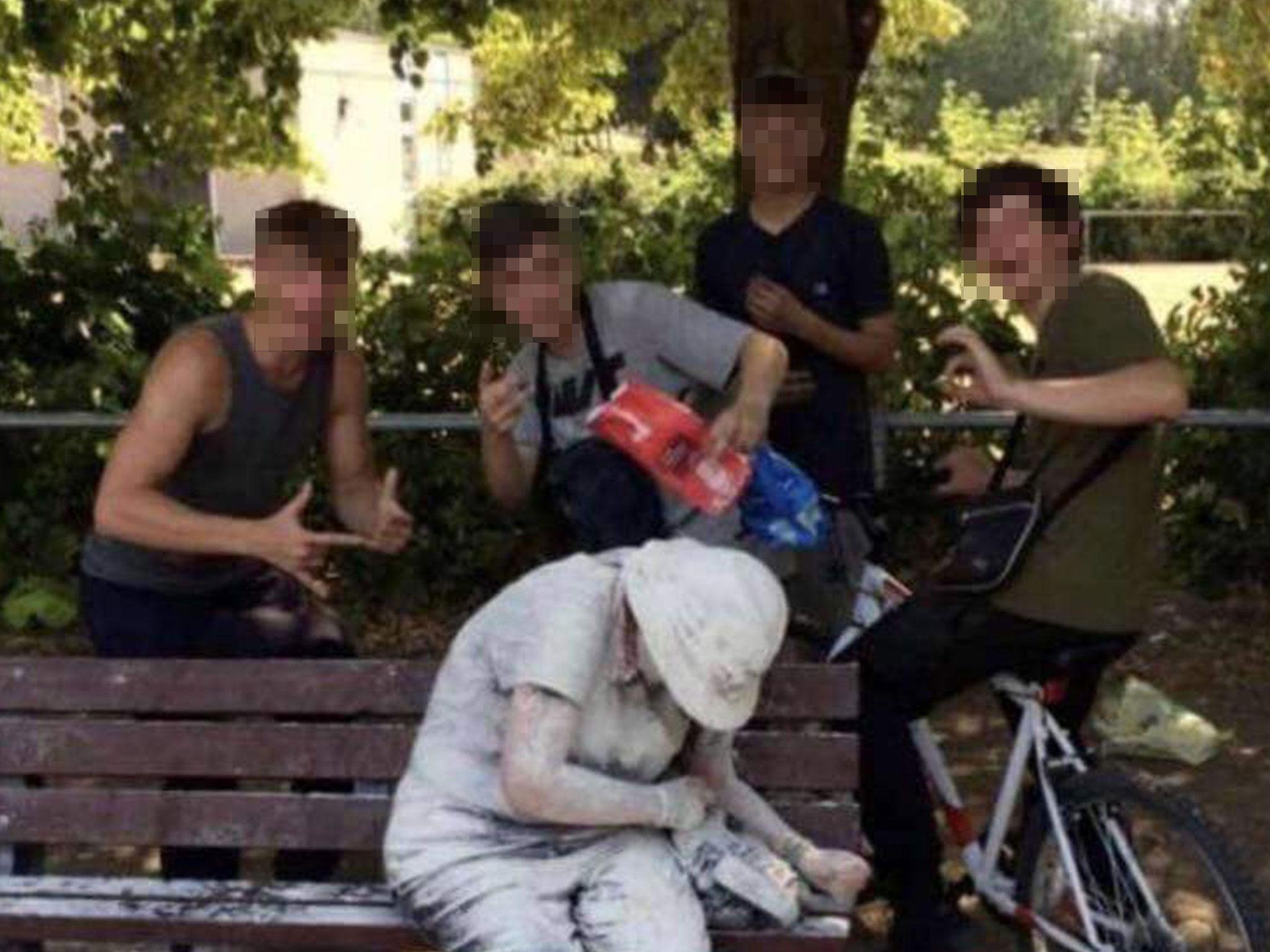 The image of four teenagers surrounding a woman covered in flour was originally shared on Snapchat
