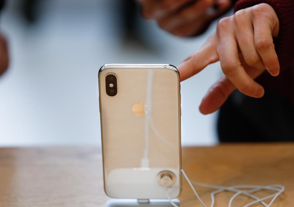 A customer touches the screen of the new iPhone X at the Apple Store Union Square on November 3, 2017, in San Francisco, California