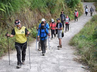 File: Indonesian and foreign climbers walk down from Mount Rinjani at Sembalun village in Lombok, Indonesia