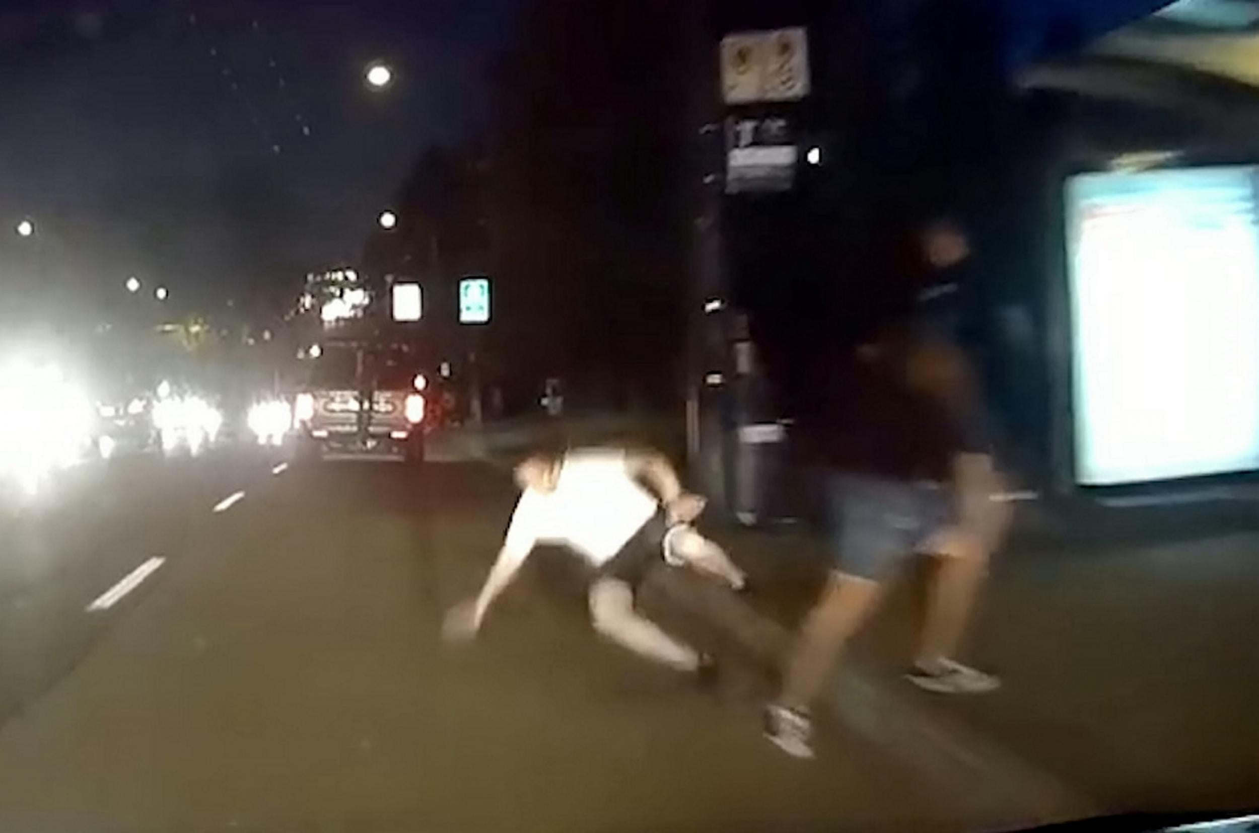 Video shows 'shocking ' moment angry man pushes complete stranger in front of oncoming traffic