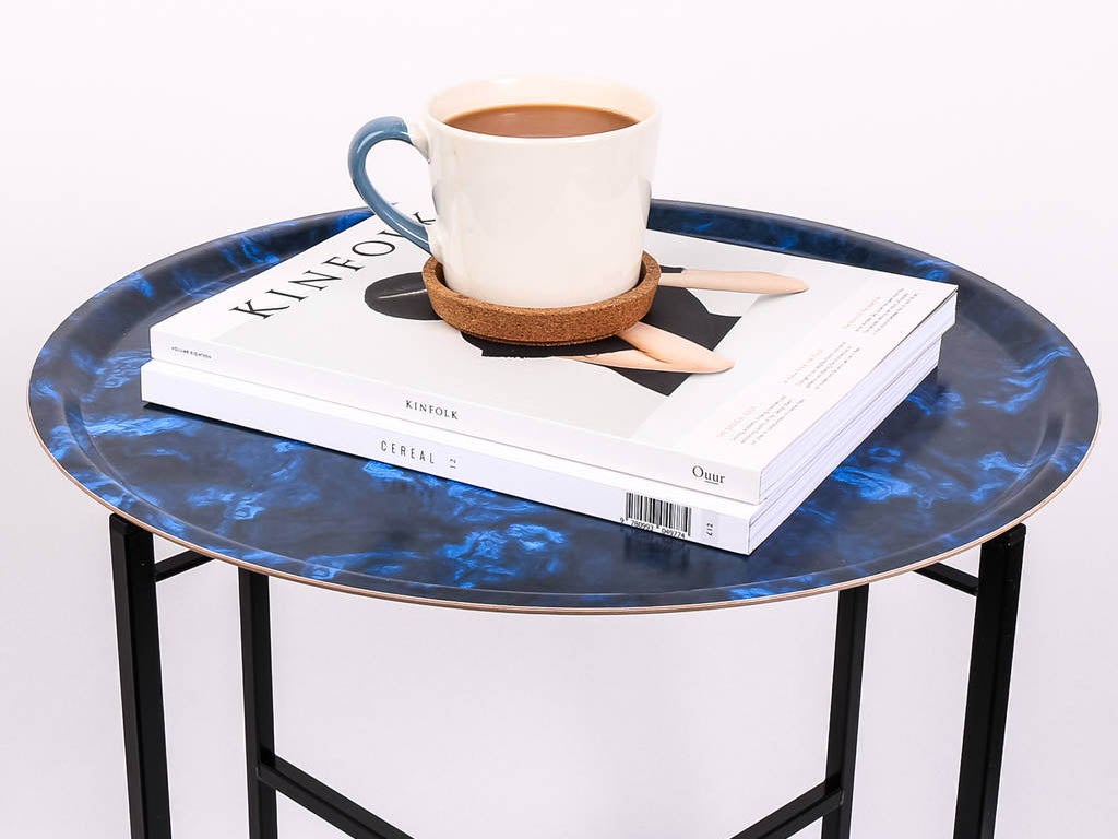 MAiK's tray tables come with a foldable steel stand that allows it to be to be turned into a side table