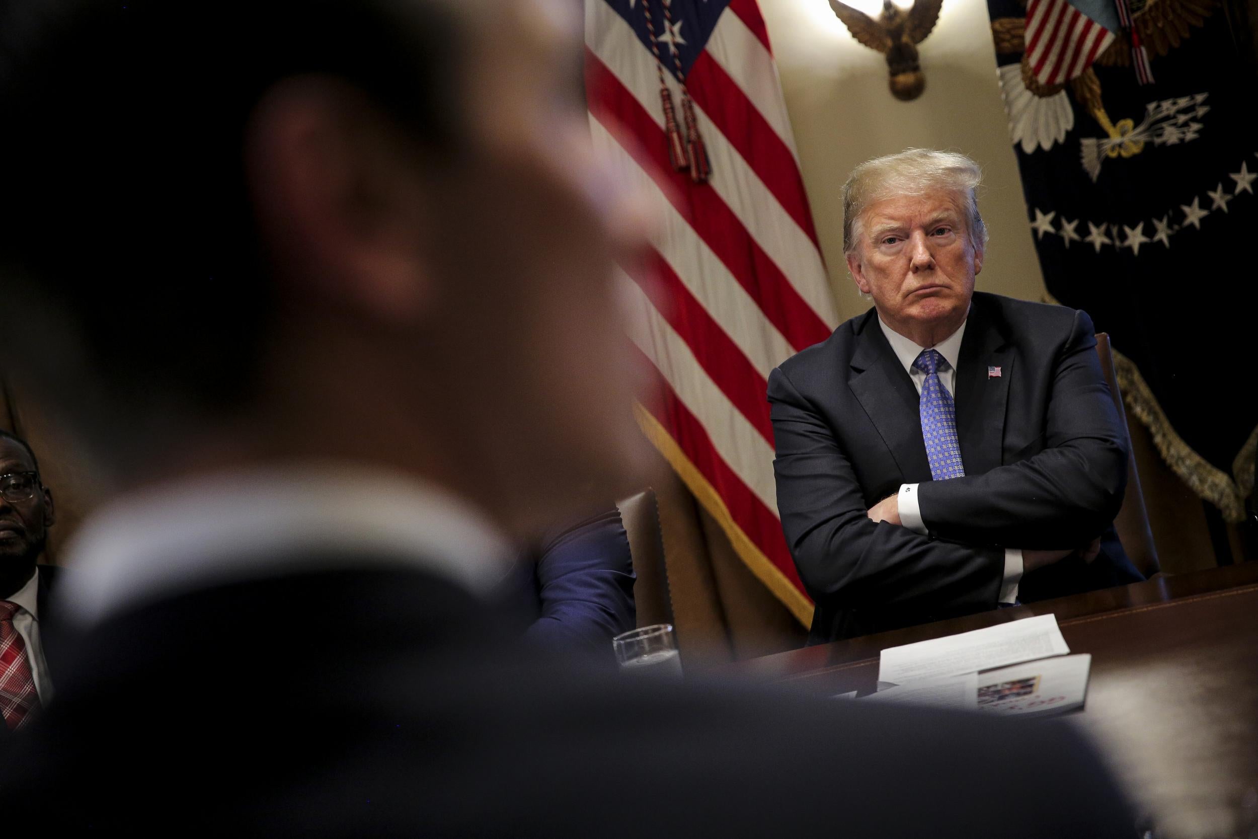 US President Donald Trump listens during a meeting at the White House in Washington
