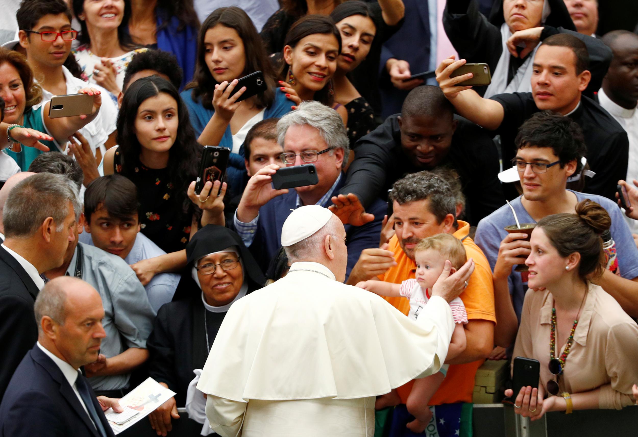 Pope Francis greets a child as he arrives to lead the general audience at the Paul VI Hall in Vatican, 1 August, 2018.