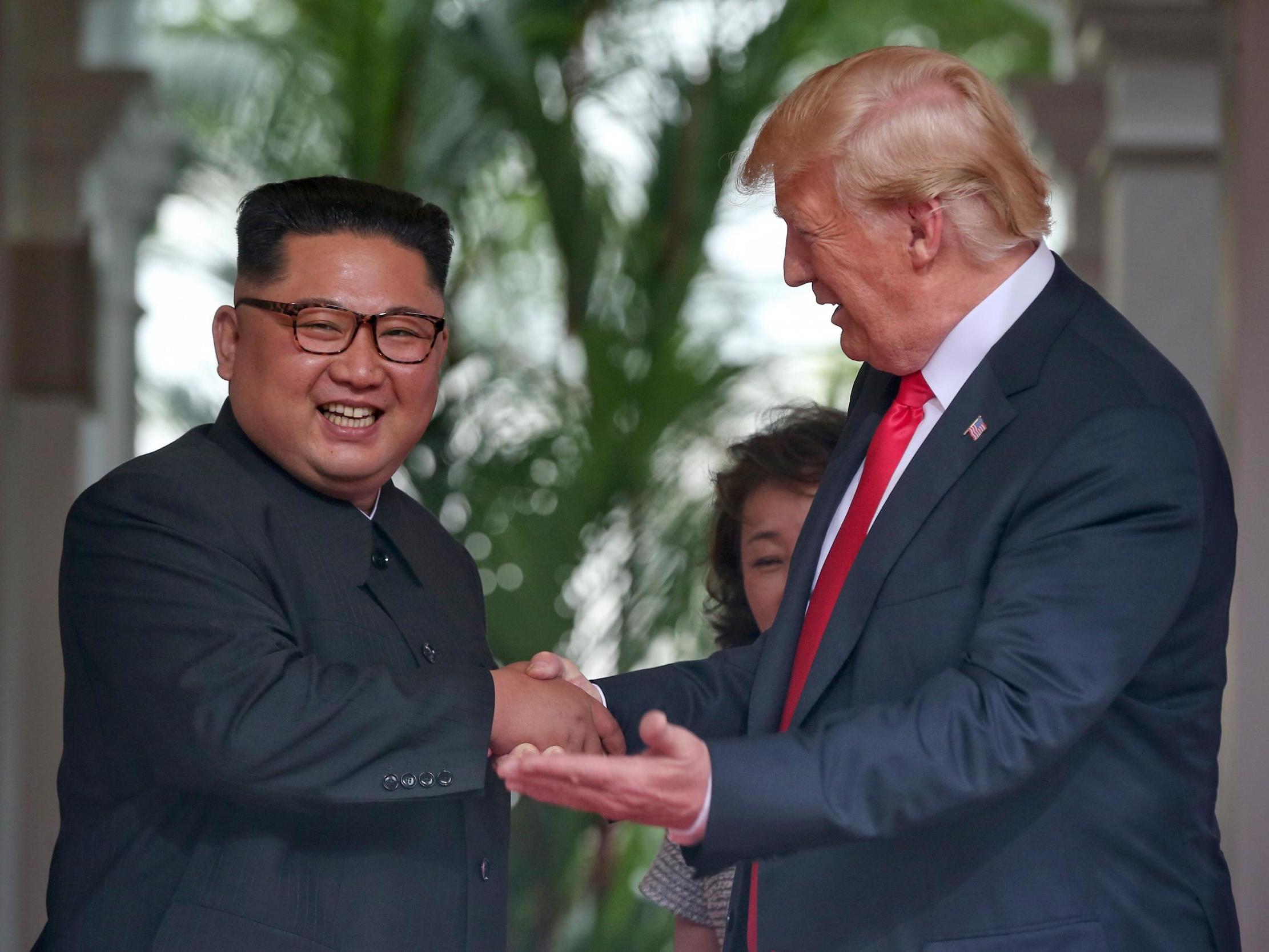 North Korean leader Kim Jong-un shakes hands with US President Donald Trump during their historic US-DPRK summit