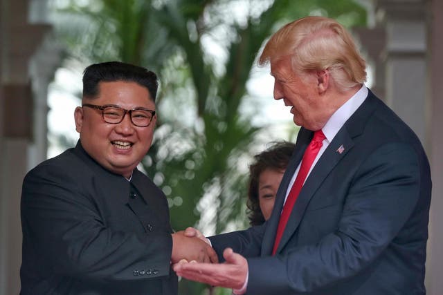 North Korean leader Kim Jong-un shakes hands with US President Donald Trump during their historic US-DPRK summit