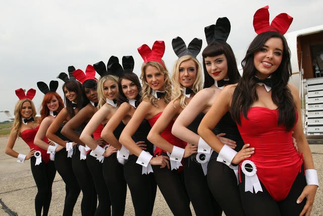 Playboy Bunnies pose airside ahead of the arrival of Playboy founder Hugh Hefner at Stansted Airport