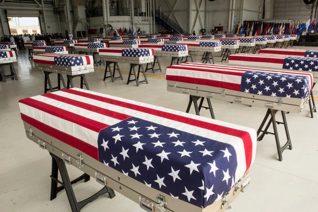 The presumed remains of US soldiers in 55 caskets draped with American flags