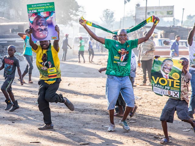 People in Mbare celebrate after officials announce the re-election of President Emmerson Mnangagwa