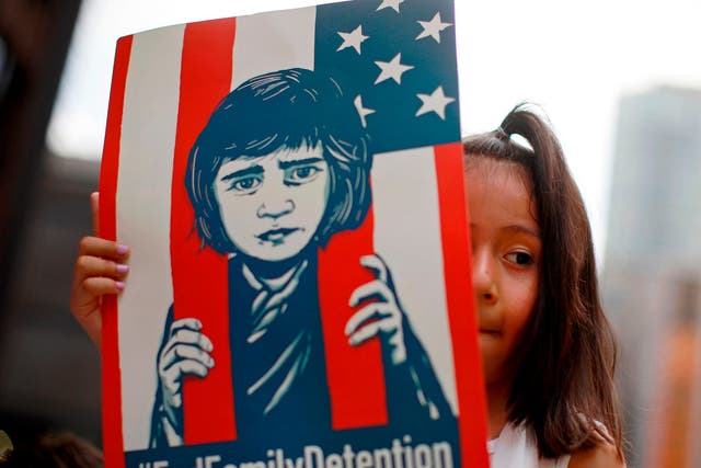 A girl takes part in a protest in Chicago against the US immigration policies separating migrant families.
