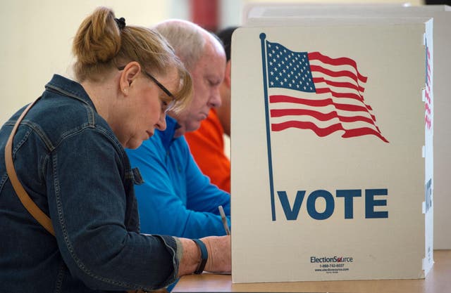 People cast their votes for US president November 8, 2016, at Centerville High School, in Centreville, Virginia