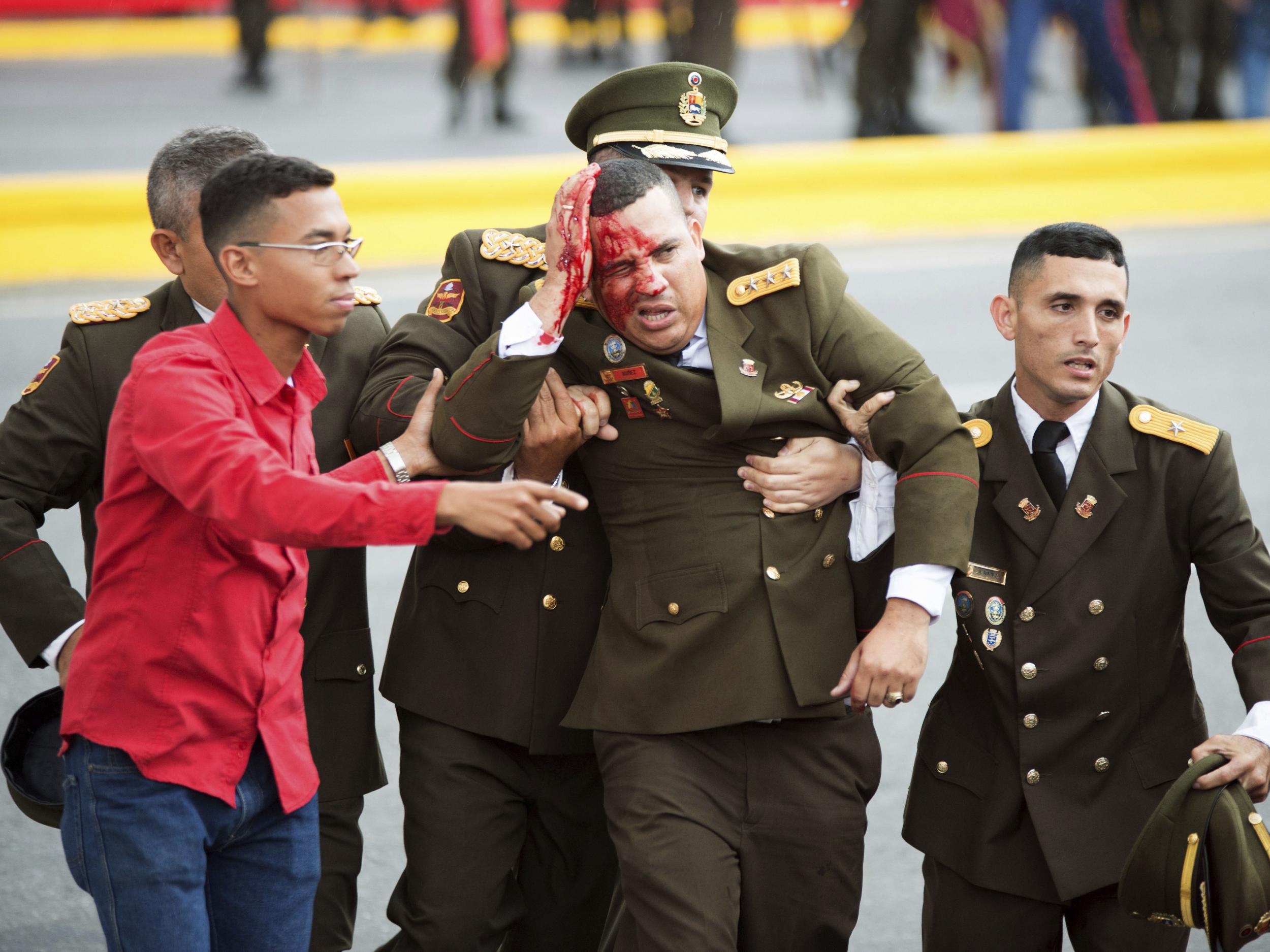 A soldier bleeds from the head following the incident in Caracas on Saturday