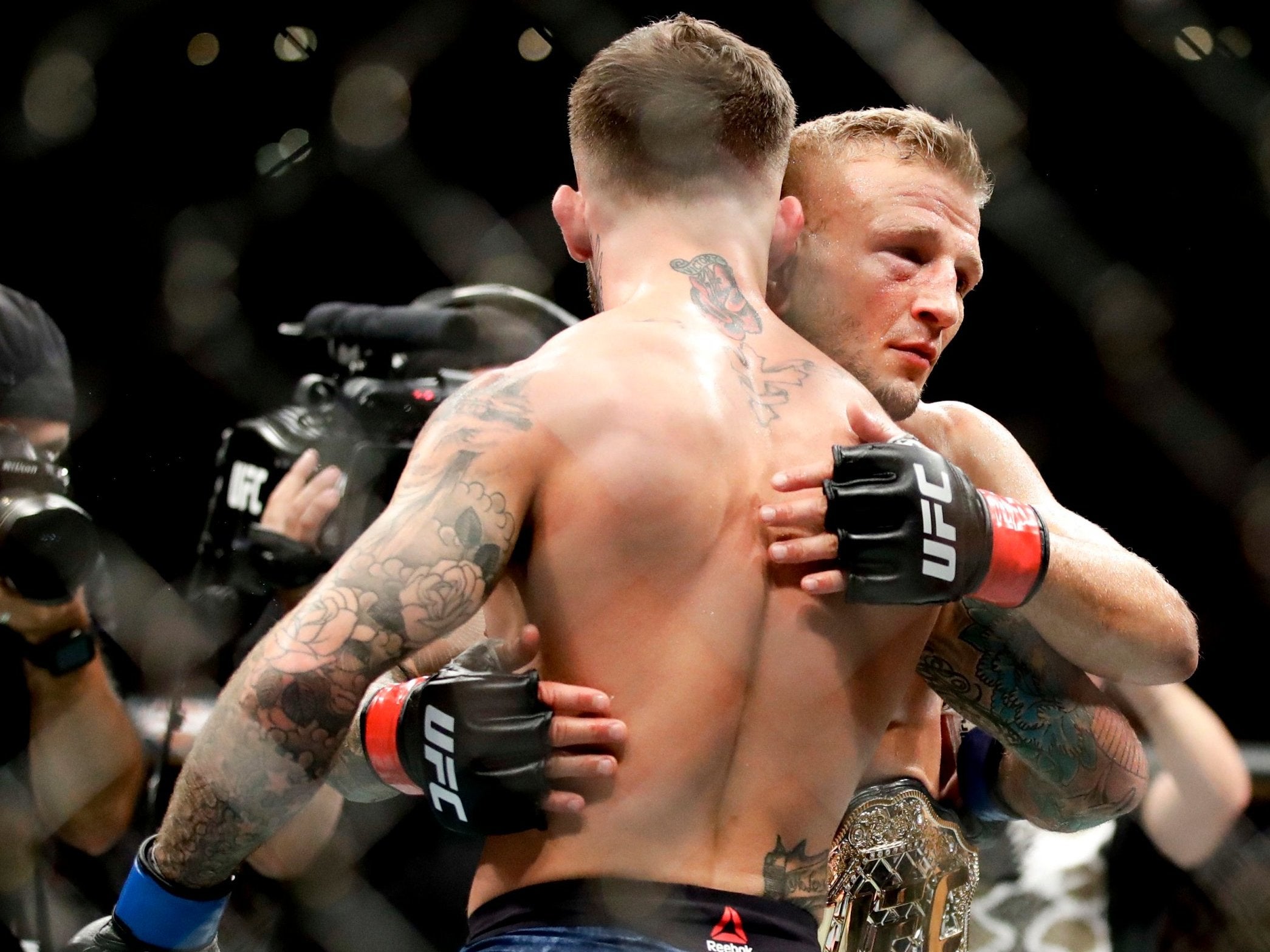 TJ Dillashaw and Cody Garbrandt embrace at the end of their second fight