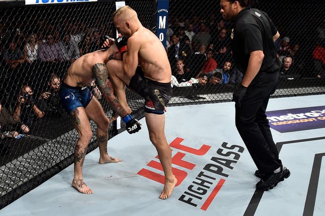 TJ Dillashaw beat rival Cody Garbrandt with a first-round stoppage to retain the UFC bantamweight title