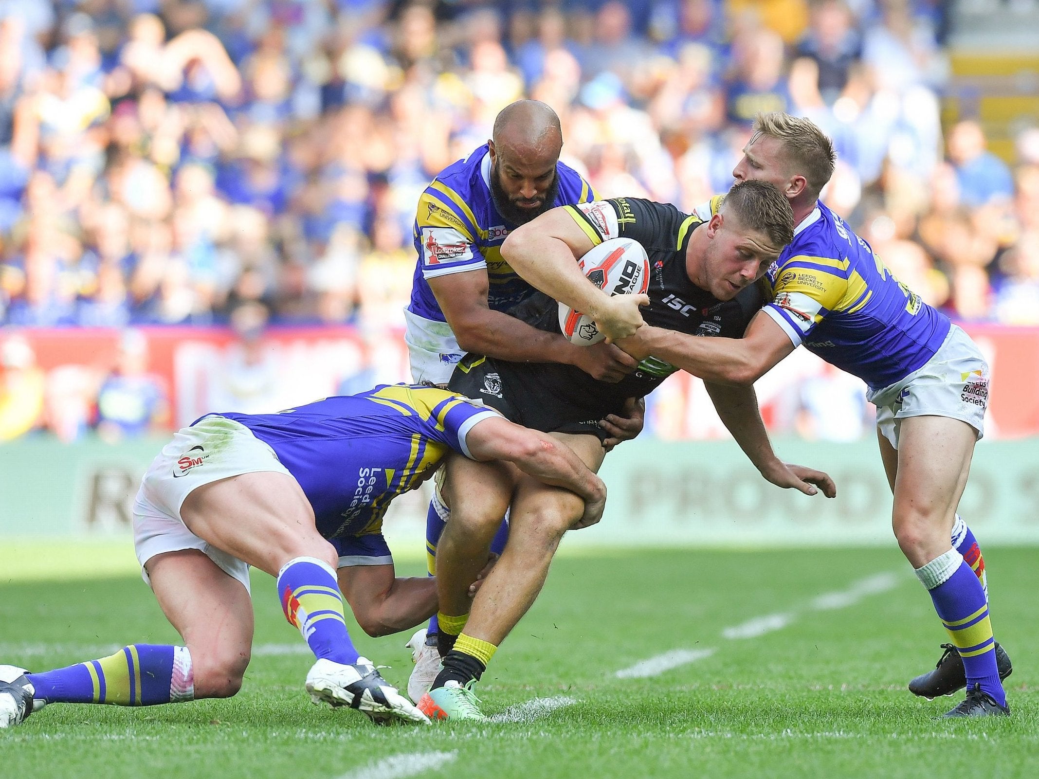 It takes three men to bring down Warrington's Tom Lineham