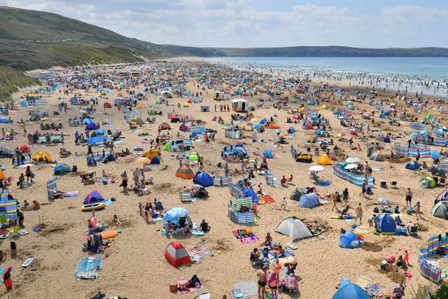 Hundreds of people took Woolacombe Beach in North Devon as the heatwave continues.