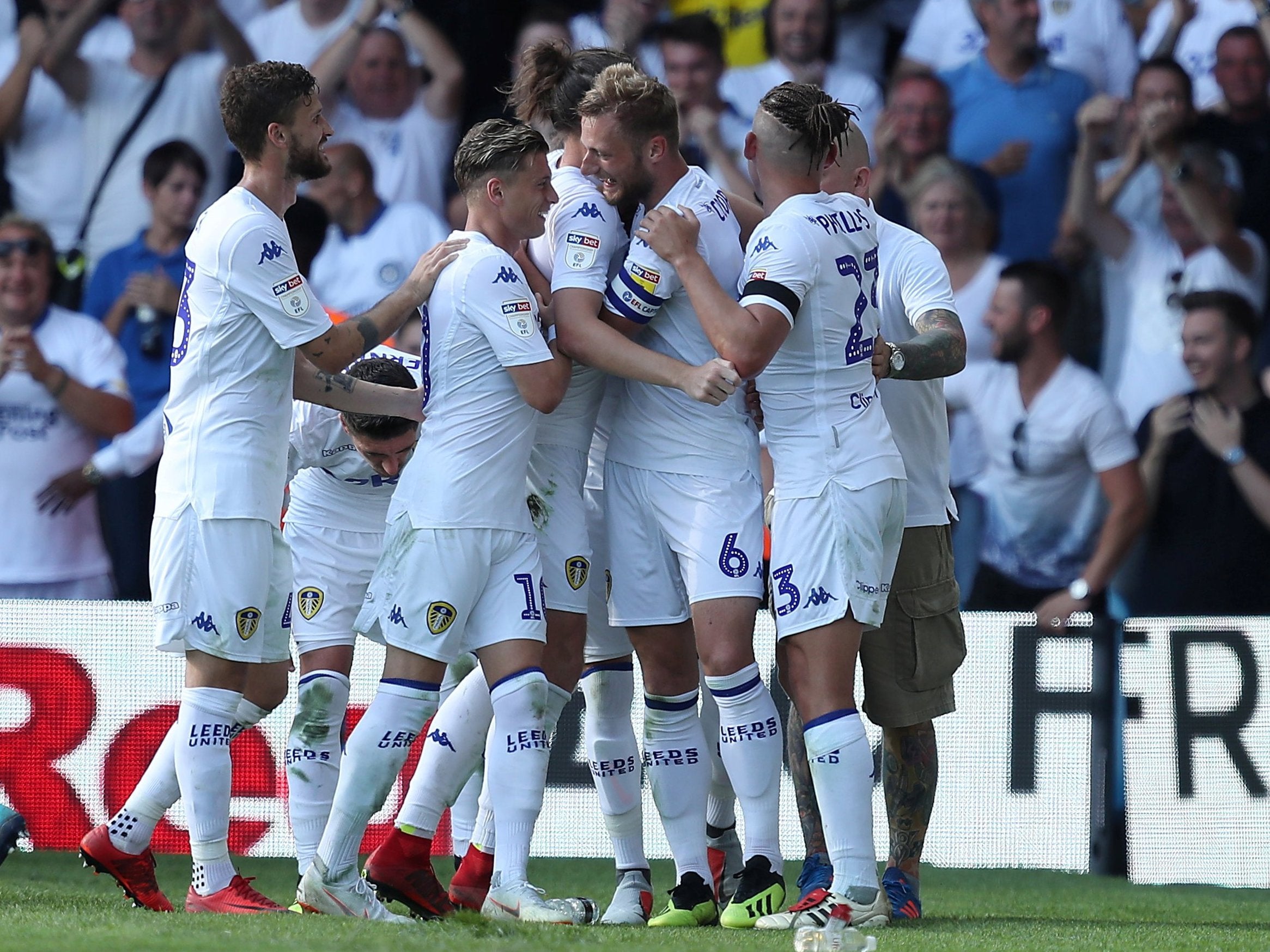Liam Cooper celebrates with his teammates after scoring Leeds' third goal