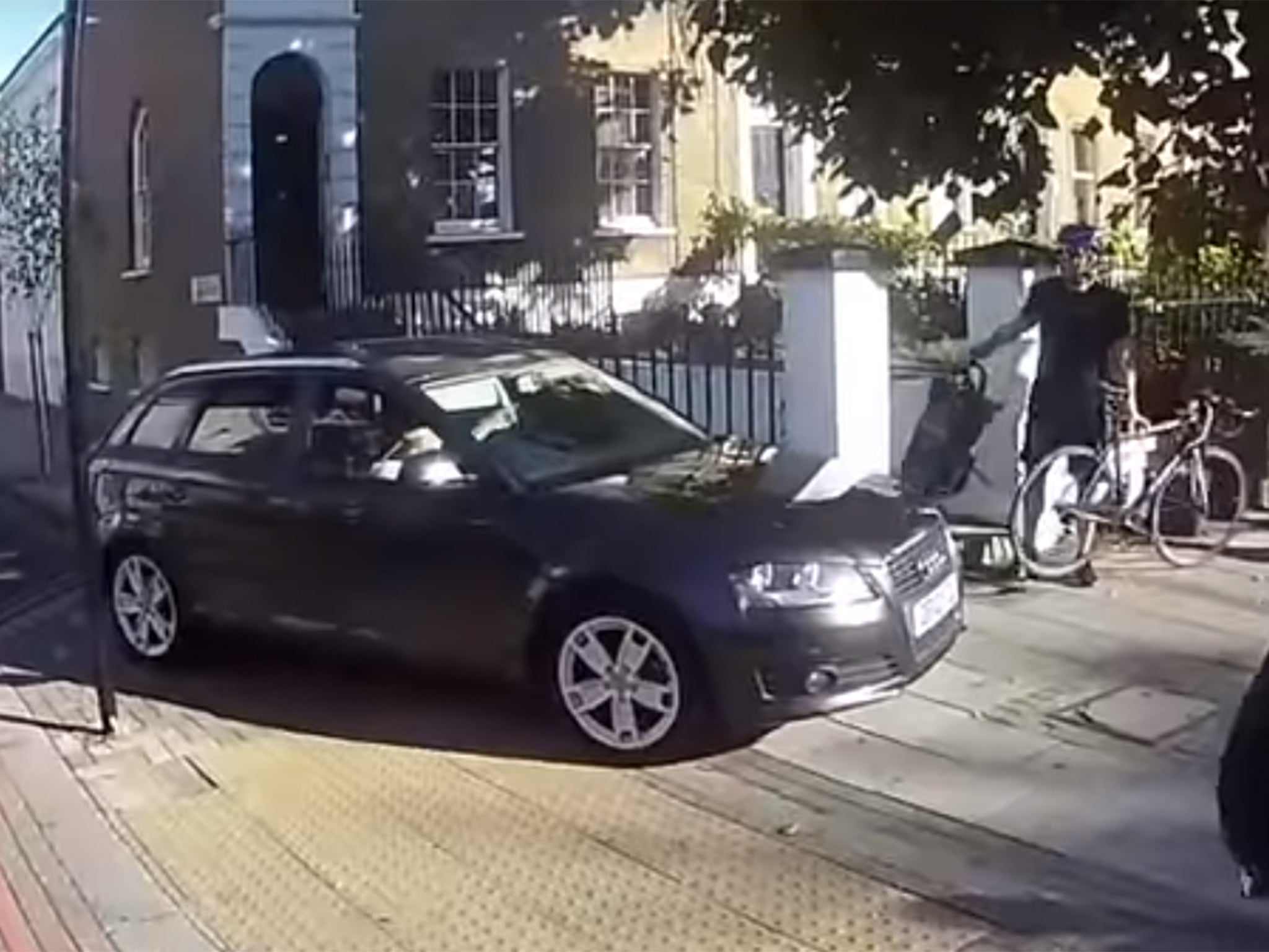 The driver is seen in the video mounting the curb and driving towards cyclists