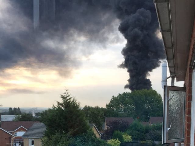 A thick plume of black smoke drifted over Manchester