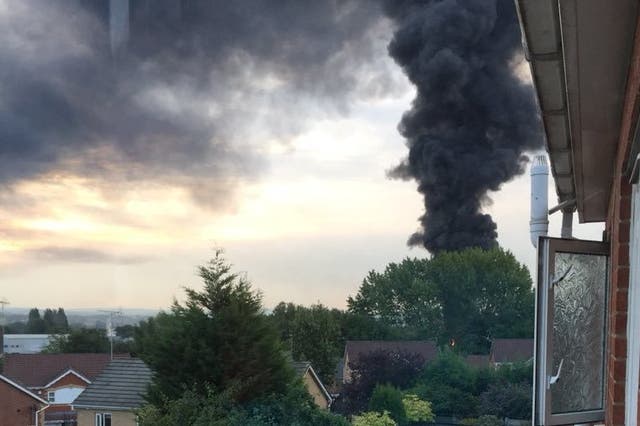 A thick plume of black smoke drifted over Manchester
