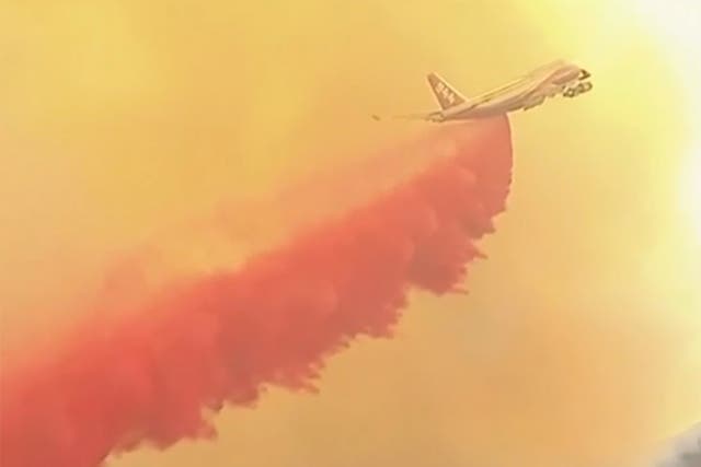 A plane issuing fire retardant