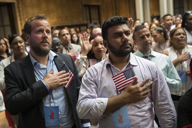 New US citizens recite the Pledge of Allegiance during naturalization ceremony at the New York Public Library