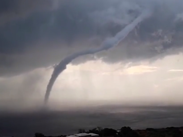 A waterspout sweeps across the Mediterranean Sea near an Italian island