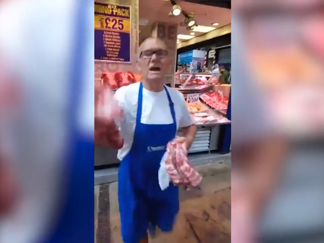 A butcher swings raw meat at vegan protesters at Kirkgate Market in Leeds