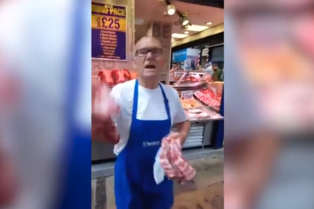 A butcher swings raw meat at vegan protesters at Kirkgate Market in Leeds