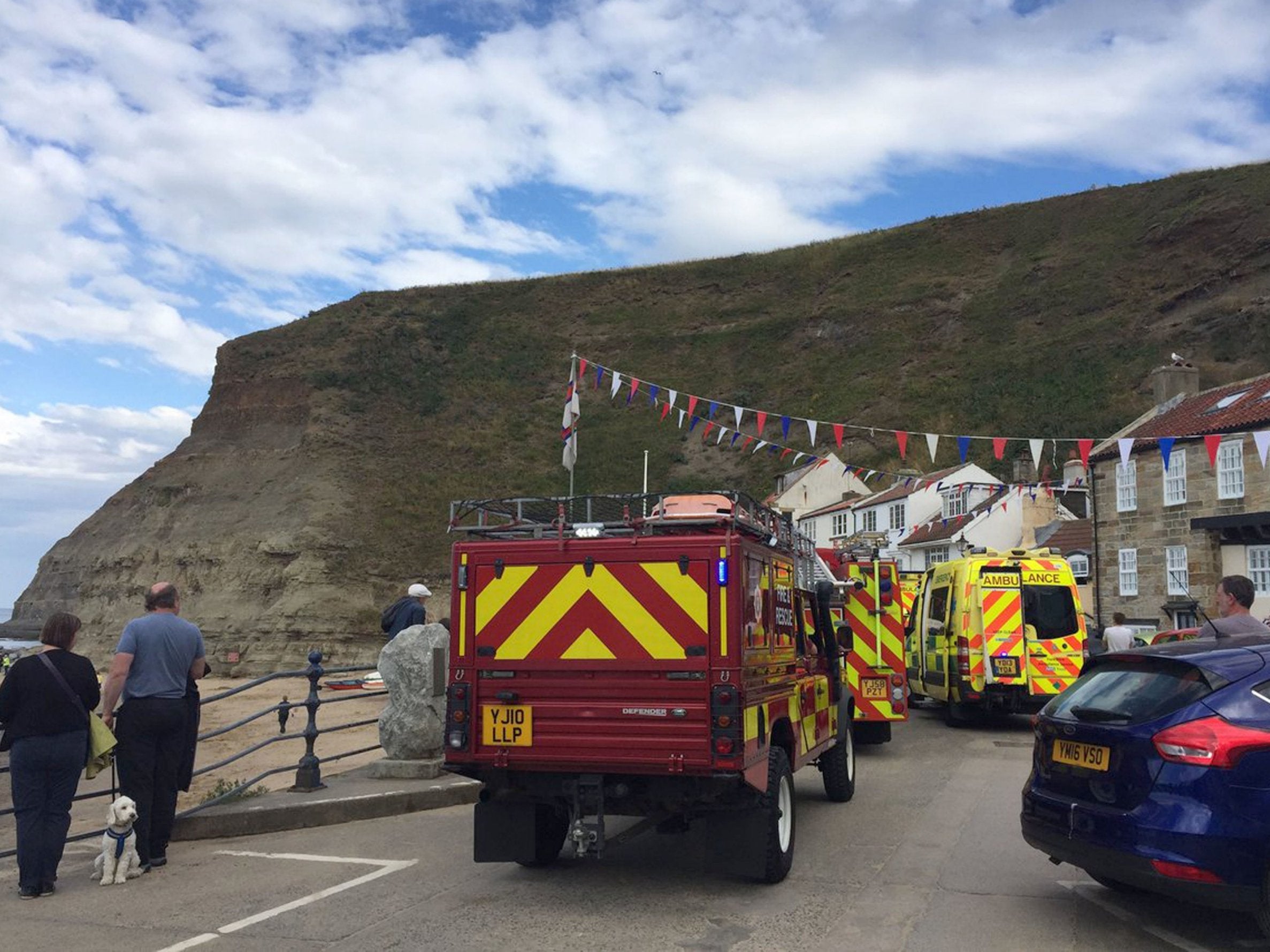Emergency services at Staithes harbour in North Yorkshire after a nine-year-old girl died in a rock fall