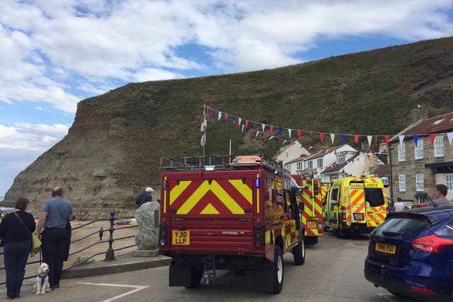 Emergency services at Staithes harbour in North Yorkshire after a nine-year-old girl died in a rock fall