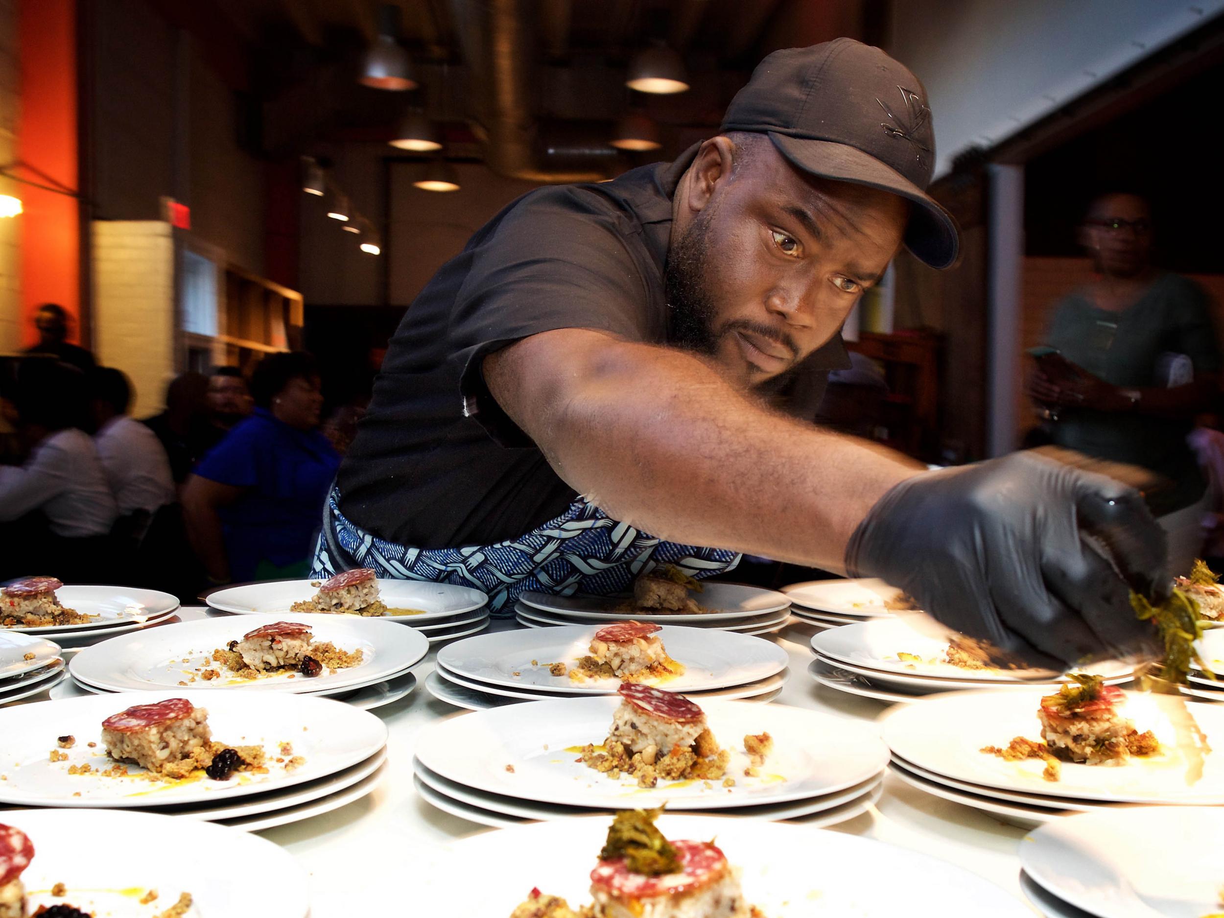 Chef Michael Bowling plates the first course at a Soul Food Sessions dinner in Washington