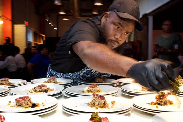 Chef Michael Bowling plates the first course at a Soul Food Sessions dinner in Washington