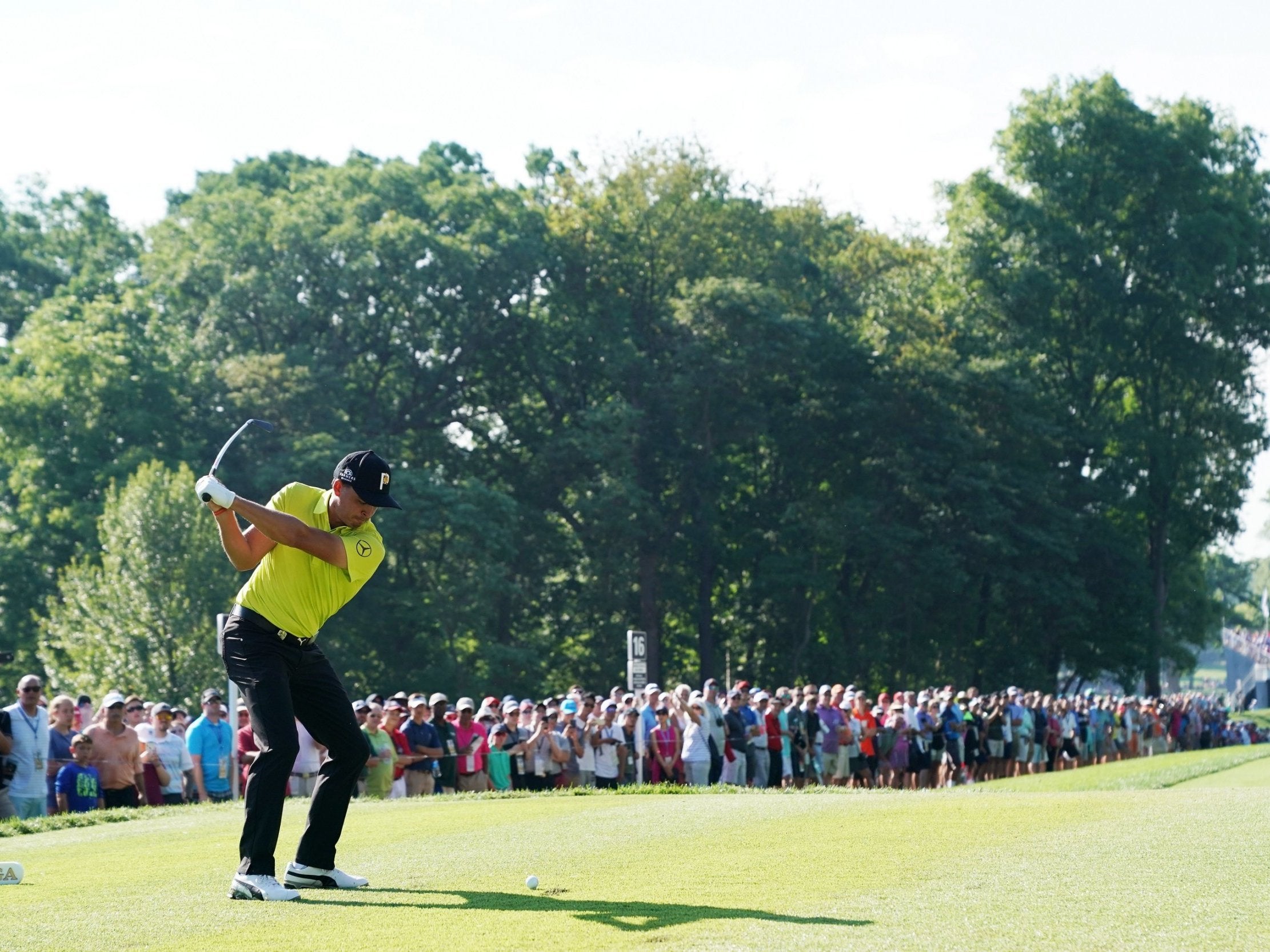 Rickie Fowler plays his tee short at the 16th hole