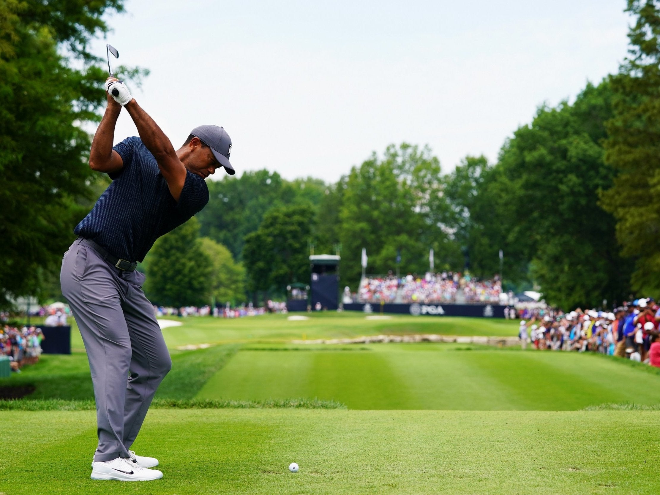 Tiger Woods plays his tee shot on the sixth hole