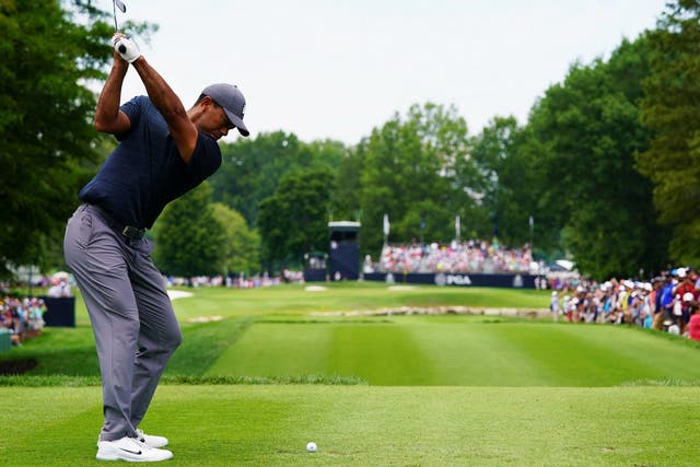 Tiger Woods plays his tee shot on the sixth hole