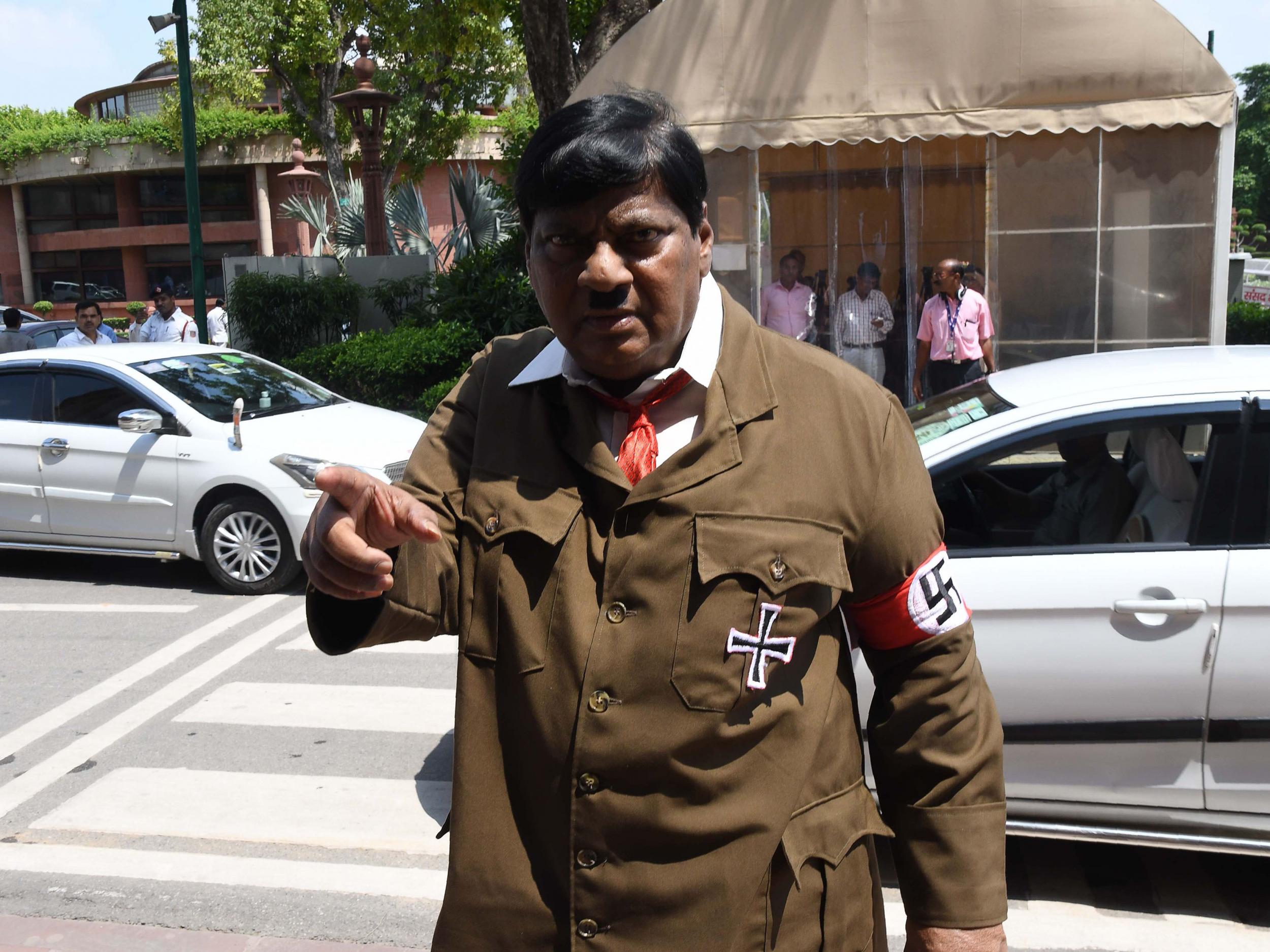 Indian film actor turned politician Naramalli Sivaprasad, arrives at parliament dressed as Adolf Hitler to press for government funding for his home state of Andhra Pradesh, in New Delhi