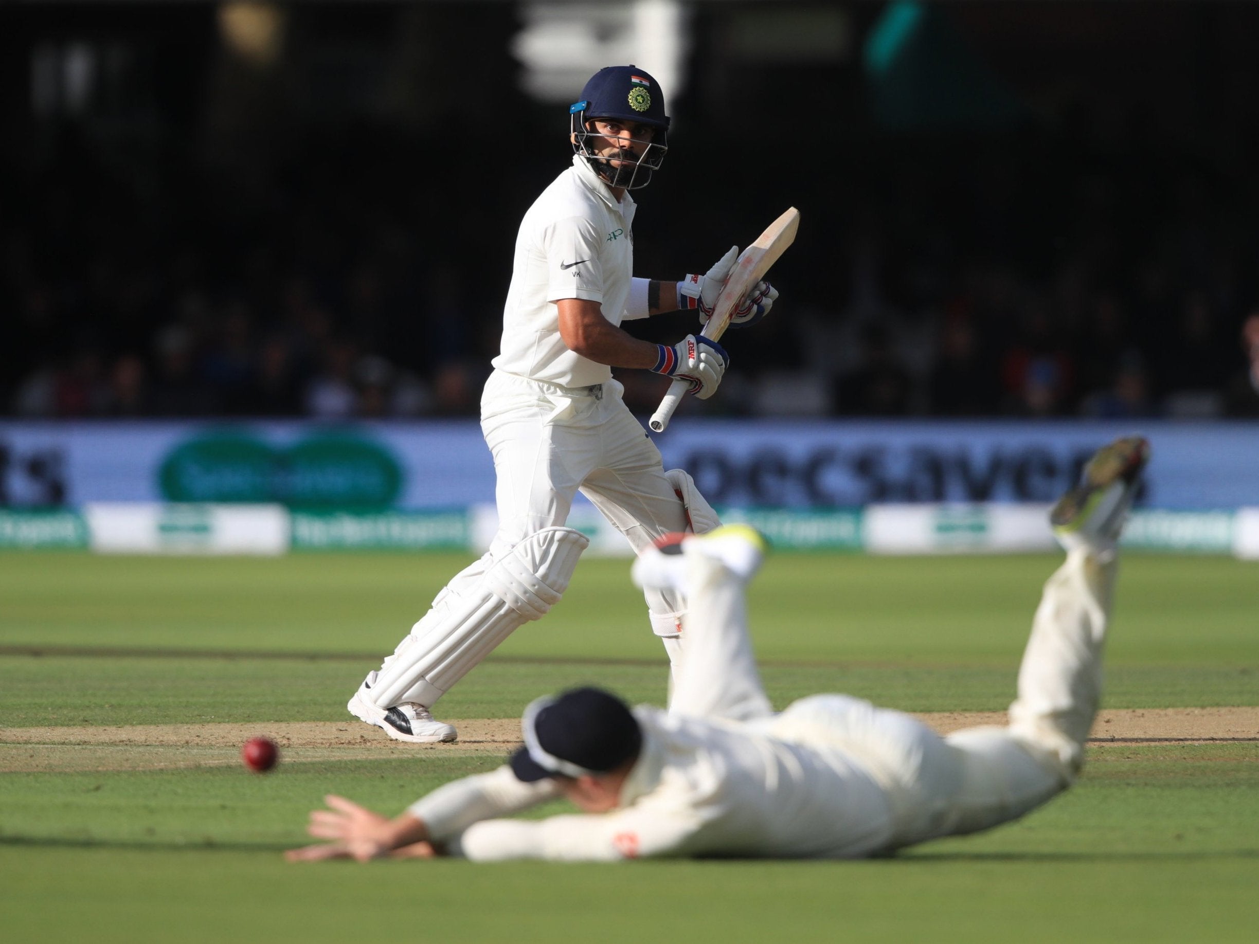 Joe Root fields a shot from Virat Kohli