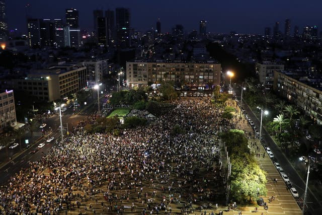 Israeli Arabs and their supporters take part in a protest rally in Tel Aviv's Rabin square
