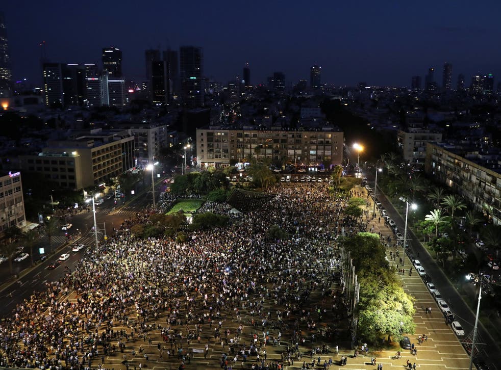 Israeli Arabs and their supporters take part in a protest rally in Tel Aviv's Rabin square