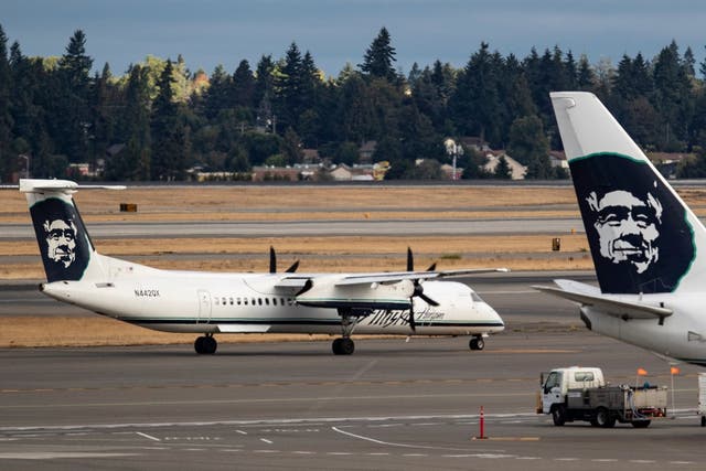 A Horizon Air Bombardier Q400 taxis toward the runway at Seattle-Tacoma International Airport