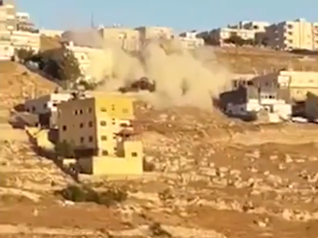 Building collapses after militants set off explosives in response to security forces raid