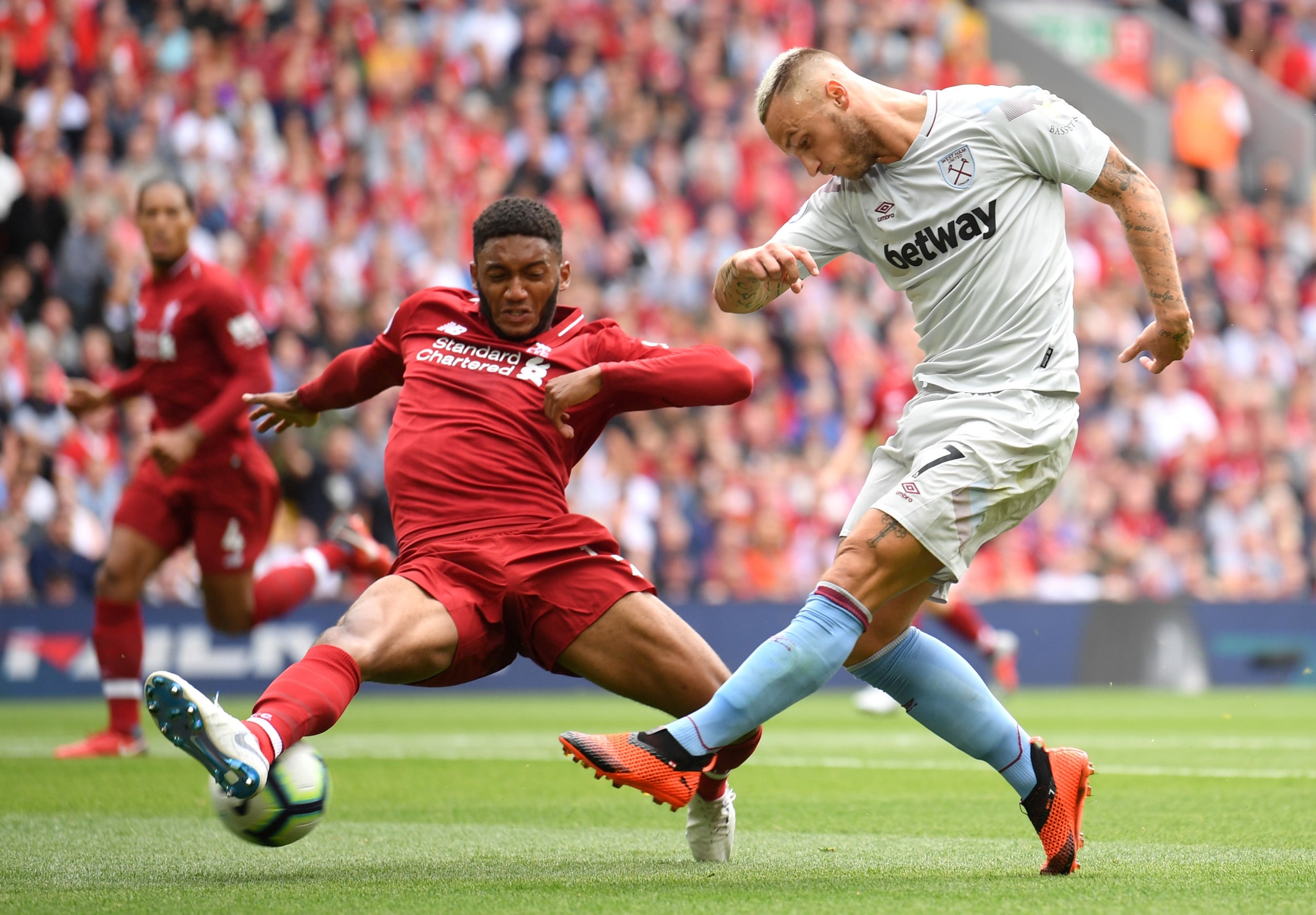 Joe Gomez blocks a shot from Marko Arnautovic