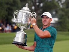 Koepka holds off Woods to win PGA Championship and make history