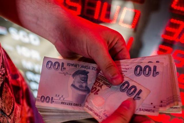 The Turkish lira has slumped to record lows against the US dollar amid growing tensions between Ankara and Washington
